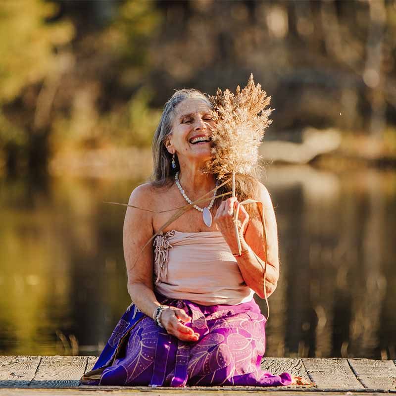 Ajeet Khalsa smiling with dried grasses by the water