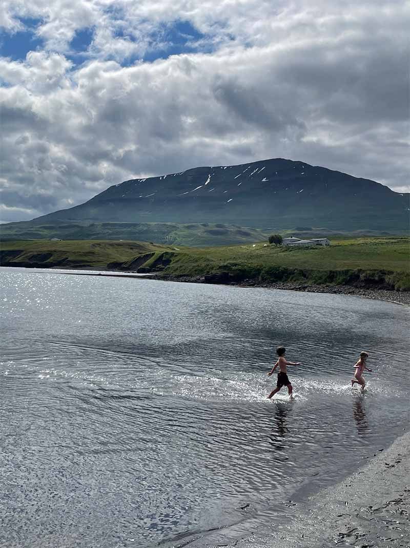Children in natural water in Iceland